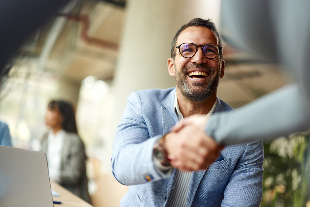 A MetalSoft customer shaking hands after reviewing their ROI business case